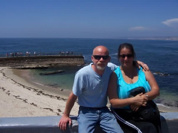 David and a woman posing by the water